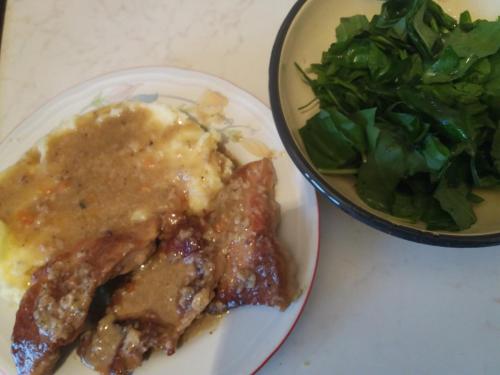 a plate of food with meat and a bowl of salad at Katun Ljeljenak in Pluzine