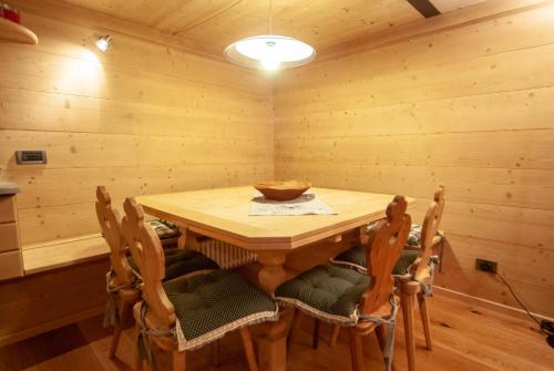 a dining room with a wooden table and chairs at Mountain Loft in Tarvisio