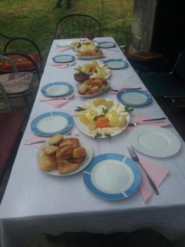 a long table with plates of food on it at Katun Ljeljenak in Pluzine