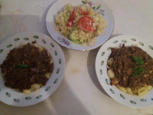 three plates of food on a table with rice at Katun Ljeljenak in Pluzine