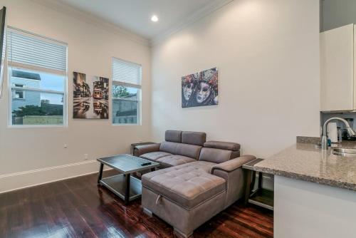 a living room with a couch and a table at Fabulous Cottages with City Views in New Orleans