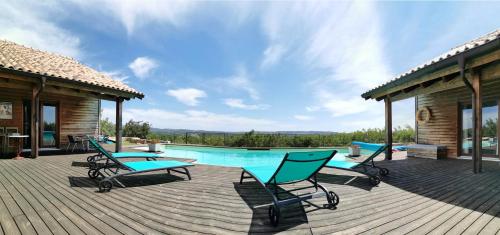 a deck with a pool and chairs and a house at Chambres d'hôtes Naturistes (Nudiste) "Cabanadelsol" - Adults Only in Monte da Charneca