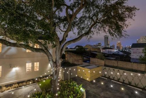 a tree on the roof of a building with lights at Fabulous Cottages with City Views in New Orleans