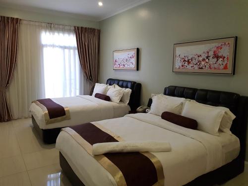 מיטה או מיטות בחדר ב-Lae City Hotel