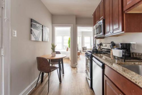 a kitchen with a table and a counter top at Lively 2BR Apt in Lincoln Square - Eastwood 47-1 in Chicago