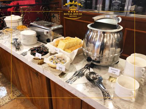 a buffet with a pot and some food on a counter at Royal House Hotel 2 in Ulaanbaatar