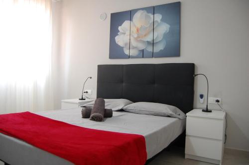 a bedroom with a large bed with a red blanket at Paradise Court Las Americas WiFi Pool 25 in Adeje