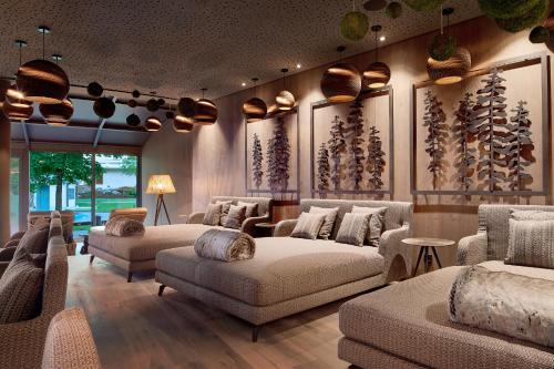 a living room with couches and chairs and a table at Krumers Alpin – Your Mountain Oasis in Seefeld in Tirol