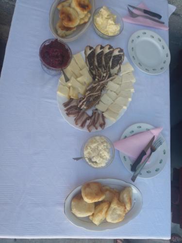 a table with different types of food on it at Katun Ljeljenak in Pluzine