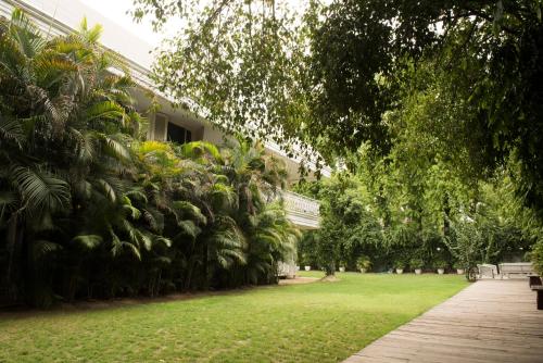 a courtyard of a building with green grass and trees at Diplomat, Chanakyapuri New Delhi- A Boutique Hotel in New Delhi