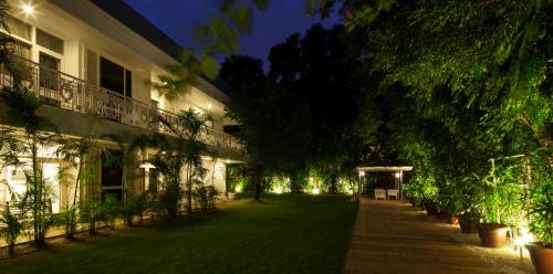 a courtyard of a building at night with lights at Diplomat, Chanakyapuri New Delhi- A Boutique Hotel in New Delhi