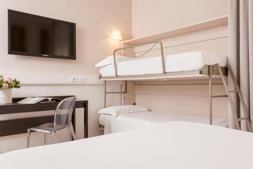 a hospital room with two beds and a flat screen tv at Hotel Villa Rosa Riviera in Rimini