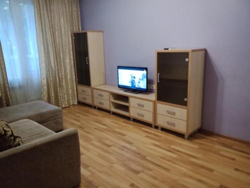 a living room with a flat screen tv and a couch at 2 к квартира между двумя станциями метро Студенческая и Академика Павлова in Kharkiv