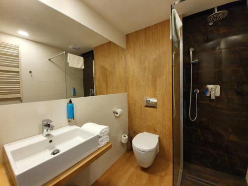 a bathroom with a sink and a toilet and a shower at Apartament w Mielenku nr 19 - 365PAM in Mielenko
