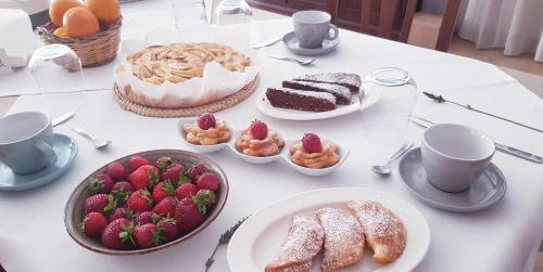 a table topped with cakes and strawberries and desserts at Agriturismo Augello in Partanna