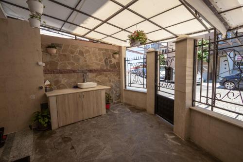 a bathroom with a sink in a room with windows at Tiffany Boutique Suits - Pomorie in Pomorie