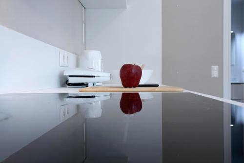 an apple sitting on a shelf in a kitchen at Sti Chora Apartments in Lefkada Town