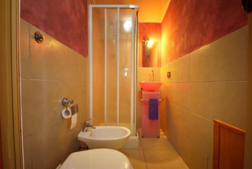 a bathroom with a toilet and a shower and a sink at Domo Sant'Antioco in SantʼAntìoco