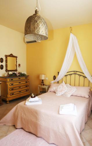 a bedroom with a large bed with a canopy at LIGURIA home in Ameglia