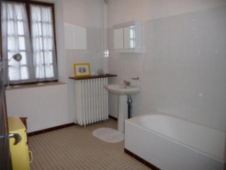 a bathroom with a toilet and a sink and a tub at Gite Des Etangs in Paulnay