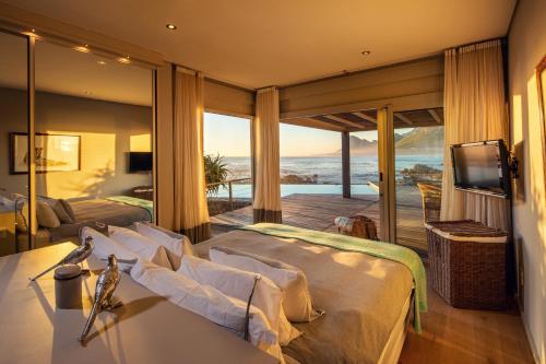 a hotel room with two beds and a television at Pringle Bay Villa by Raw Africa Collection in Pringle Bay