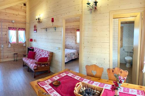 a bedroom with a bed and a table in a room at CHALET ETNA MILO in Milo