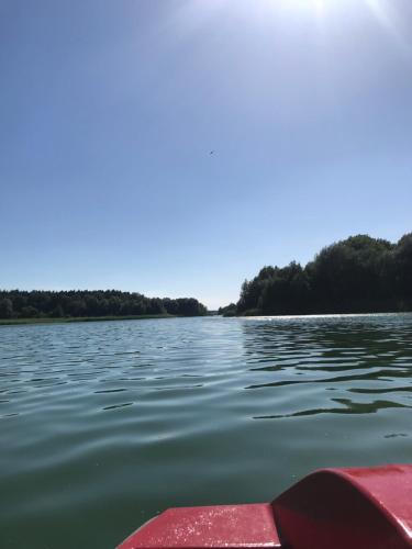 a view from the front of a boat on a lake at Domek letniskowy 6-osobowy całoroczny nad jeziorem Wilczyńskim in Świętne