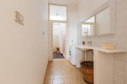 a bathroom with a sink and a washing machine at Casa Giusy by BarbarHouse in Gagliano del Capo