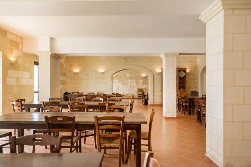 a dining room with tables and chairs in a building at Casal Dragone in Matera