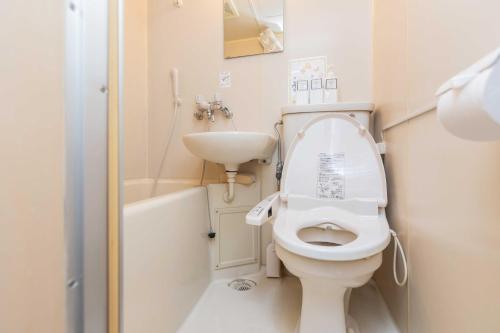 a small bathroom with a toilet and a sink at Evergreen hotel ichigaya luxe in Tokyo