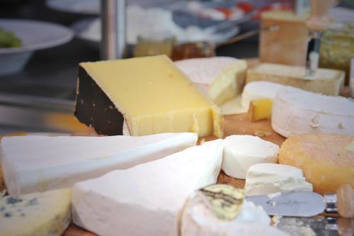 a group of cheeses and other foods on a table at Die Sandburg in Langeoog