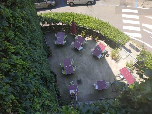 an overhead view of a patio with purple tables and chairs at Le Château in Tournon-sur-Rhône