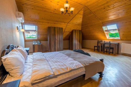 a bedroom with a large bed in a wooden ceiling at Hotel Imperial House in Tbilisi City