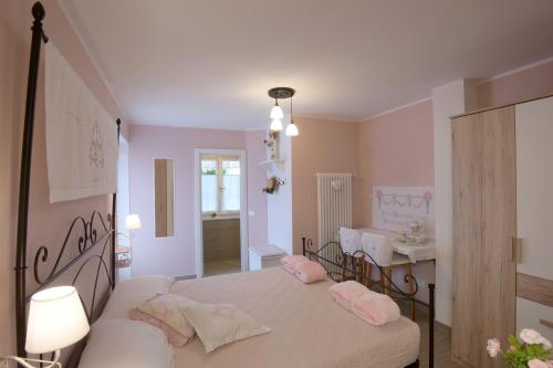 a bedroom with a bed with pink pillows on it at B&B Magiré in Tesero