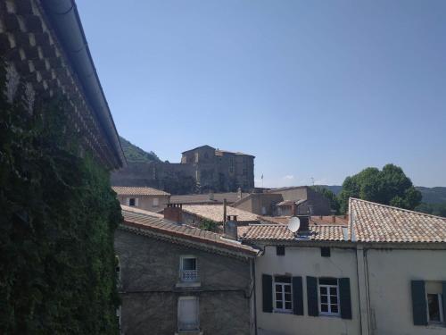 a group of buildings with a castle in the background at Le Château in Tournon-sur-Rhône