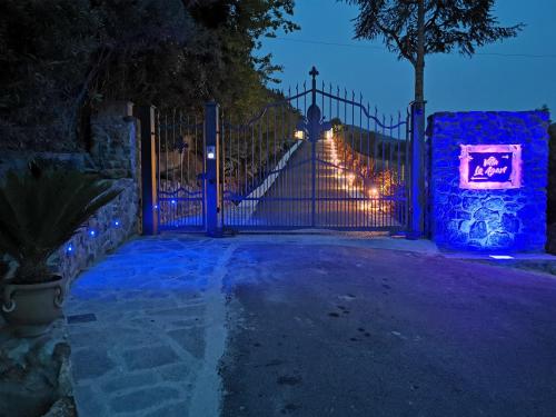 a gate with christmas lights on it at night at Villa Le Agavi & Spa in Scarlino