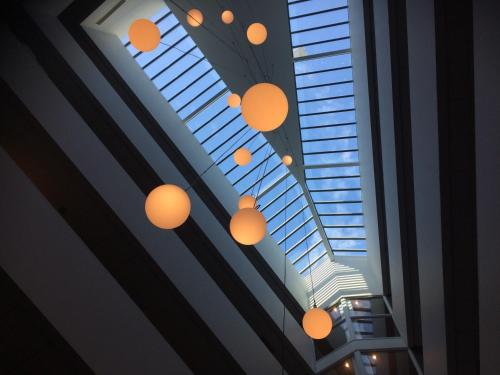 a bunch of lights hanging from a ceiling at Van der Valk Hotel Groningen-Hoogkerk in Groningen