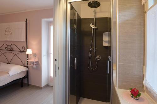 a bathroom with a shower with a glass door at B&B Magiré in Tesero