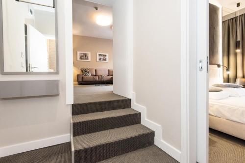 a hallway with a stairway leading to a bedroom at SeaPark Hotel Wellness & Spa in Kołobrzeg