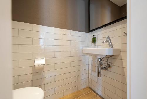a bathroom with a sink and a toilet at Hotel Rosatsch in Pontresina