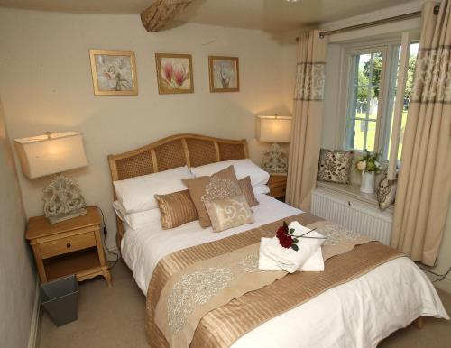 a bedroom with a large bed and a window at No 2 in Kirkby Lonsdale