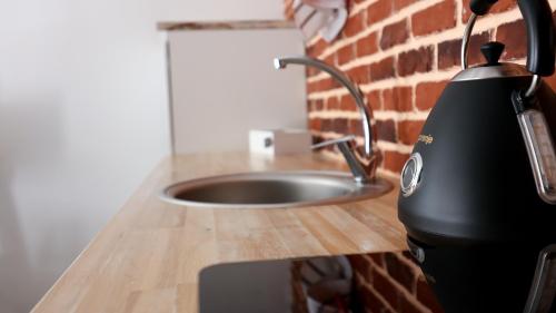 a kitchen counter with a water mixer on a counter top at UNIRII OLD SQUARE APARTMENTS 4 in Timişoara