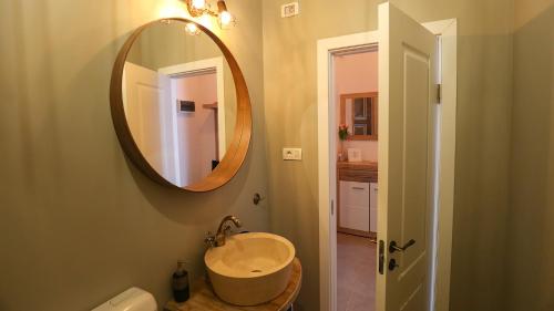 a bathroom with a sink and a mirror at UNIRII OLD SQUARE APARTMENTS 4 in Timişoara