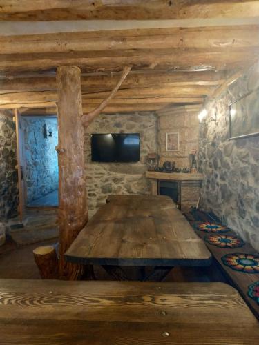 a large wooden table in a room with a tv at ВИЙГ in Sapareva Banya