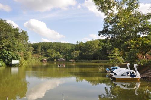 a small boat sitting in the middle of a lake at Laya Leisure Resort & Spa in Kalawana