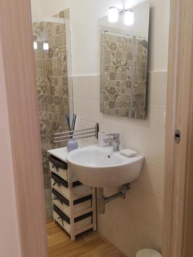 a bathroom with a sink and a mirror at Sicitaly taormina in Taormina
