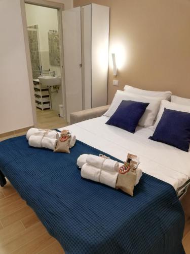 a bedroom with a large bed with towels on it at Sicitaly taormina in Taormina
