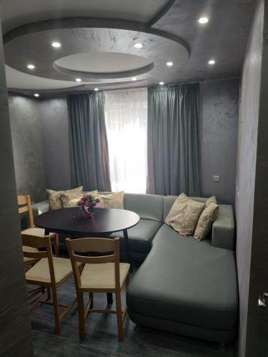 a living room with a couch and a table at ВИЙГ in Sapareva Banya