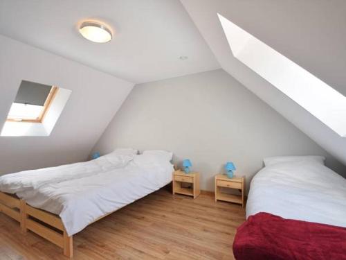 a bedroom with two beds and two night stands at WCZASOWISKO TOLKOWO in Jarosławiec