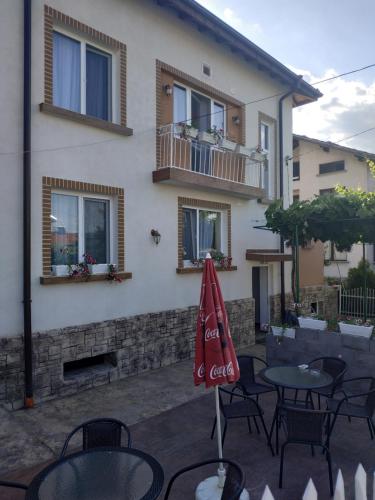 a patio with a table and chairs and a building at ВИЙГ in Sapareva Banya